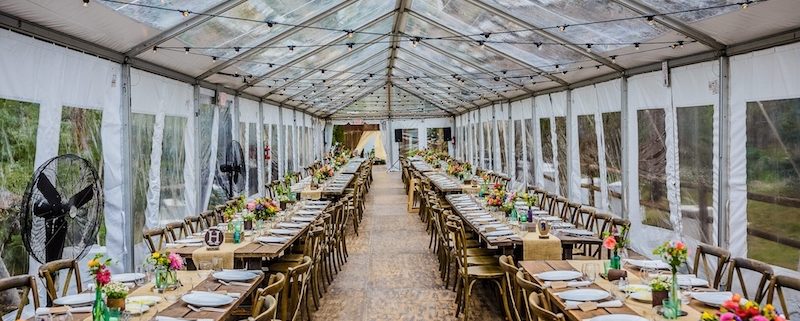 Clear Tent Rental With Bistro Lighting, Wooden Strata Flooring, Farm Tables & X Back Chairs