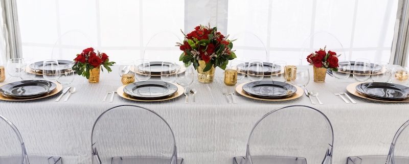 Modern Tablescape With Ghost Chairs, Round Black China & Stemless Wine Glasses & charger rentals for wedding