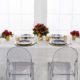 Modern Tablescape With Ghost Chairs, Round Black China & Stemless Wine Glasses & charger rentals for wedding