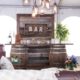 Whiskey Barrel Bar, Barnwood Decor Wall, Edison Bulb Chandelier & Pecan Lounge Furniture - Rustic Wedding Decor Rentals