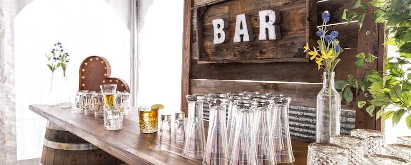 Rustic wedding ideas - Rustic Whiskey Barrel bar rental for wedding, Pilsner Glasses & Barnwood Decor Wall With Bar Sign