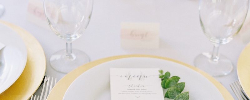 Place Setting With Deco Silverware, Napa Glassware, White wedding china rental & Gold chargers wedding in Vail, Colorado