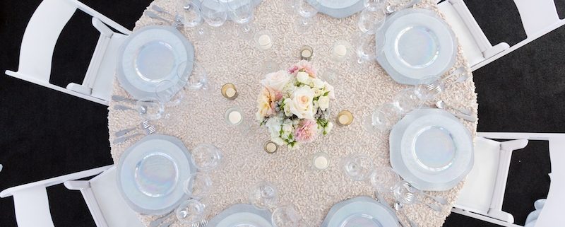 White Padded Wedding Chairs With Luster China, Hammered wedding silverware rental & Black Astro Turf