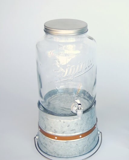 https://www.tentsandevents.com/wp-content/uploads/2023/05/6.1-mason-jar-galvanized-metal-bucket-octagon-martha-beverage-dispenser-black-stand-1.jpg